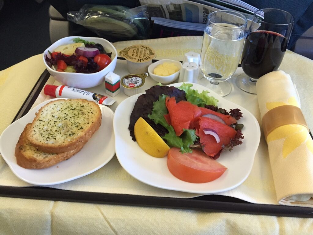 A lot of delicious foods and drinks on plane.