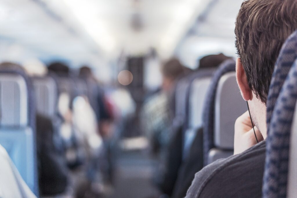A man is sitting on a plane