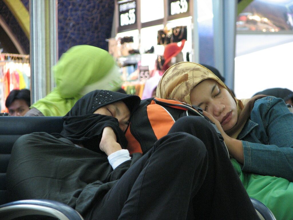 Passengers sleep leaning against each other.